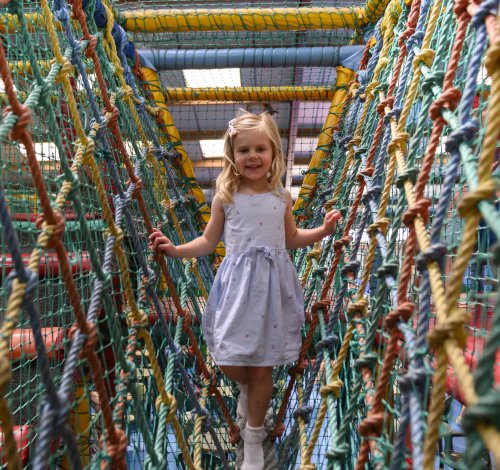 Playbarn girl walking across rope